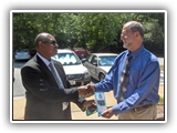 Photo of Gen Boroh shaking hands with Dr. Harvey Langholtz.